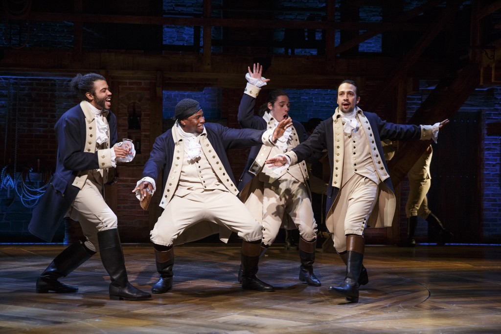 The historic characters in Hamilton wear period dress but their hip-hop singing and dance movements are rooted in the 21st century. From left, Daveed Diggs, Okieriete Onaodowan, Anthony Ramos, and Lin-Manuel Miranda in the title role. Photo: Joan Marcus.