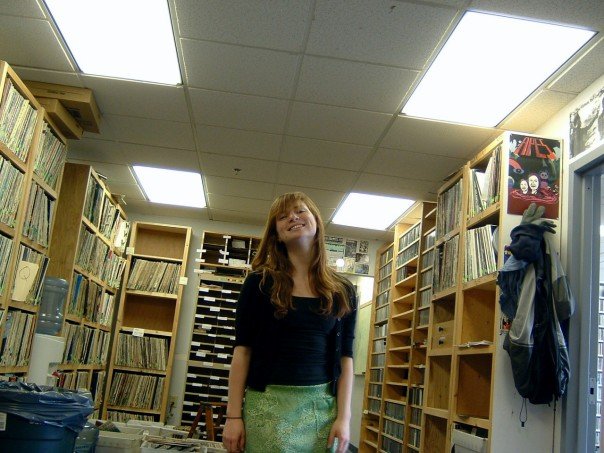 Andrea is in the WESU studios, surrounded by shelves of records