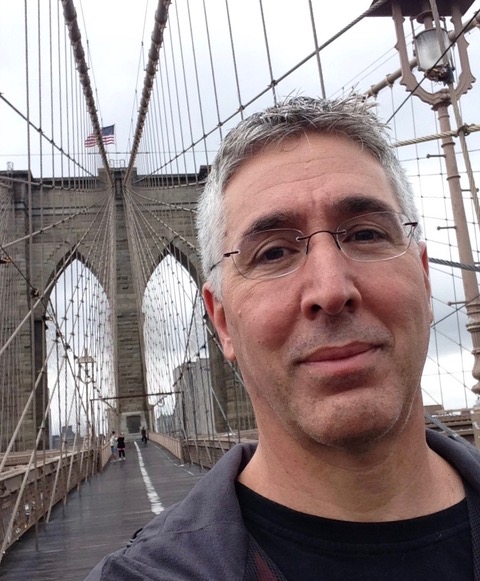 Dough Berman stands on a bridge.