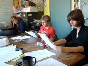 Students sit at the WESu station looking at their script 